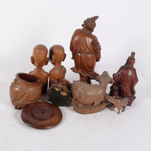 165 - A group of Oriental hardwood carvings, various tourist pieces, including various fish man statue fig... 