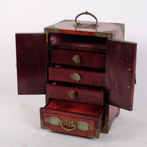 166 - A modern softwood Chinese table-top jewellery box cabinet, with hinged brass mounts, inlaid carved d... 