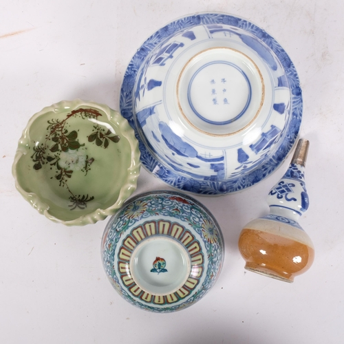 168 - A group of modern Oriental ceramic items, including a blue and white centrepiece bowl, with 6 charac... 