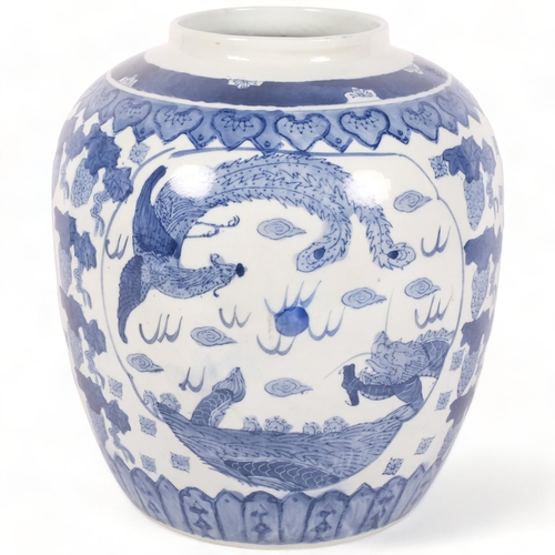 174 - A large blue and white Chinese ginger jar, with transfer printed dragon or mythical creature decorat... 