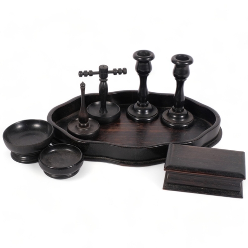 181 - A late 19th or early 20th century ebony dressing set, on associated tray, tray length 27.5cm