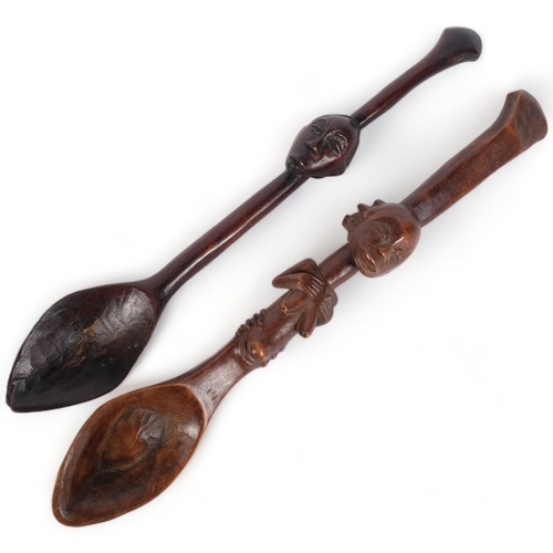 185 - 2 similar African Tribal wooden spoons, likely tourist pieces, larger spoon has fertility carving in... 