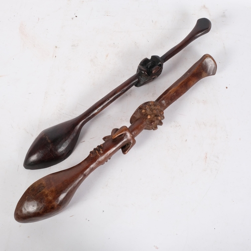 185 - 2 similar African Tribal wooden spoons, likely tourist pieces, larger spoon has fertility carving in... 