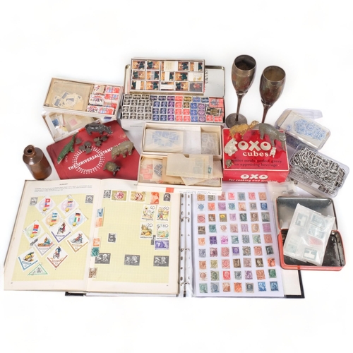 217 - A selection of British and worldwide stamps, many loose, several stock books, and a Vintage Oxo Cube... 