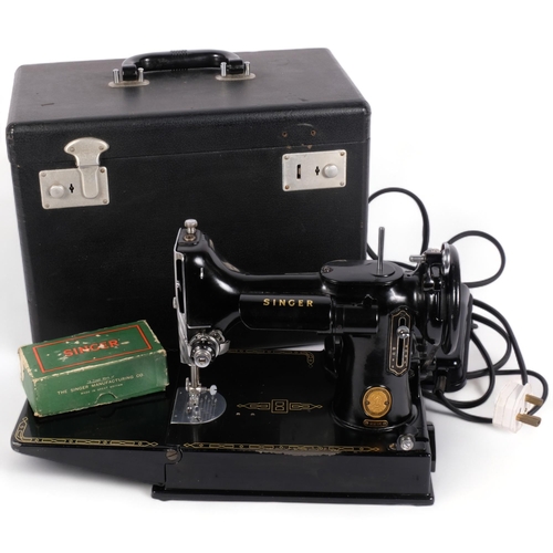 219 - A Vintage Singer Featherweight 221K sewing machine, with associated case and accessories, case 36cm ... 