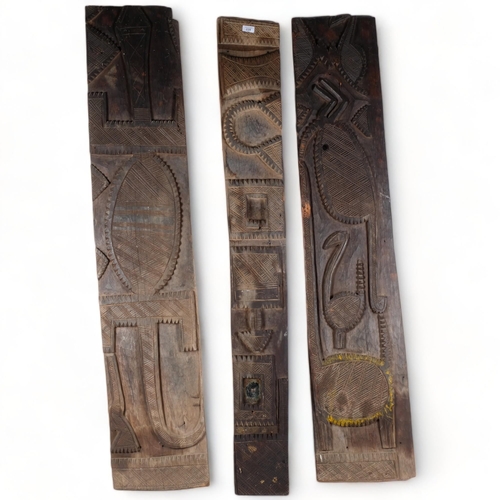 228 - A group of 3 carved African wood wall plaques, depicting various Tribal motifs and animals, etc, lar... 