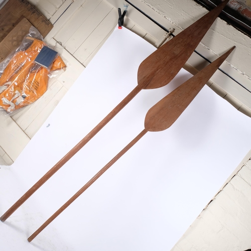 240 - 2 large wooden African paddles, largest length 220cm