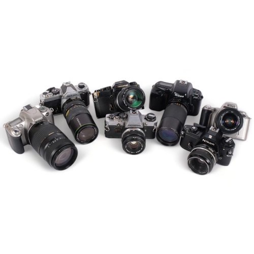 242 - A selection of Vintage cameras and associated lenses, including an Olympus OM10, and various Nikon c... 