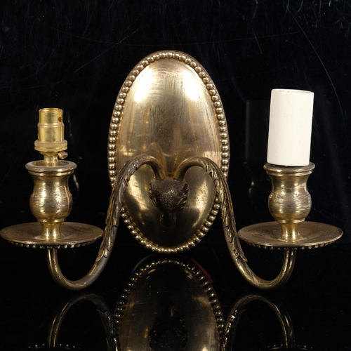 249 - A pair of brass wall sconces with ram's head decoration (2)