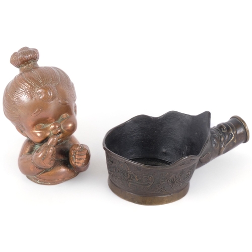 256 - A Chinese silk iron, and a hollowed brass mid-century mould, used for casting rubber dolls, H14.5cm ... 