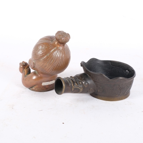 256 - A Chinese silk iron, and a hollowed brass mid-century mould, used for casting rubber dolls, H14.5cm ... 