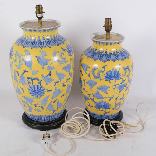 260 - 2 similar large ceramic vases, with blue and yellow Oriental decoration, ebonised wooden bases, both... 