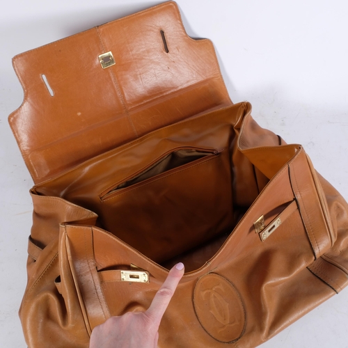 299 - A light tan brown leather holdall, with interwoven stitched monogram, bag length 46cm, depth 31cm, w... 