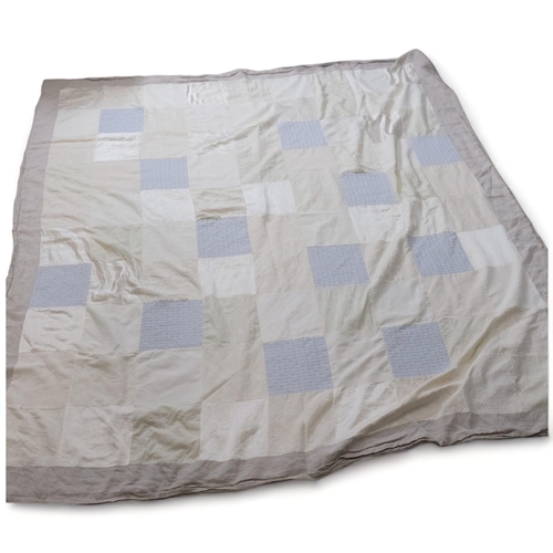 303 - LARA HOLMES, British, a large handmade patchwork bed cover, silk, linen and cotton panels with rever... 