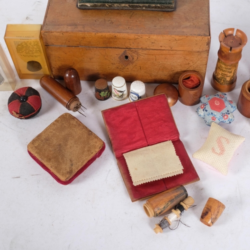 377 - A Victorian walnut sewing box and contents, including treen sewing boxes, pin cushions, thimbles, et... 