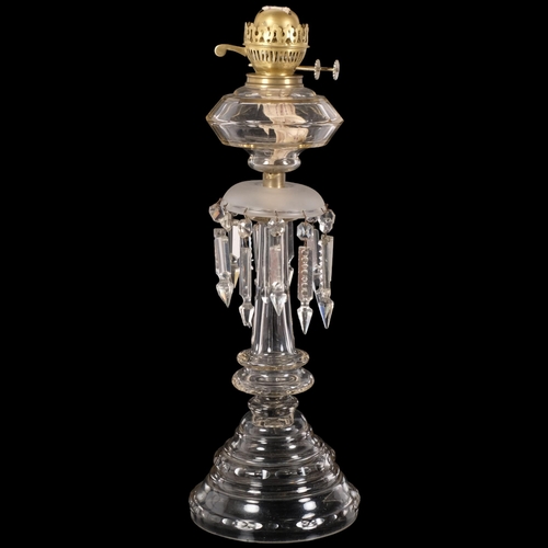 64 - An Antique oak oil lamp, with panelled glass font and arrowhead lustre drops, H56cm