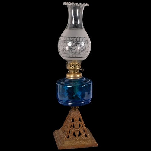 68 - A Victorian glass and gilt-metal oil lamp, with etched shade and frilled edge, blue glass font on a ... 