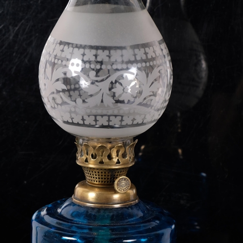 68 - A Victorian glass and gilt-metal oil lamp, with etched shade and frilled edge, blue glass font on a ... 