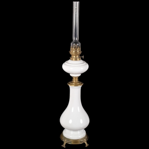 69 - An Art Nouveau brass and white ceramic oil lamp, H80cm