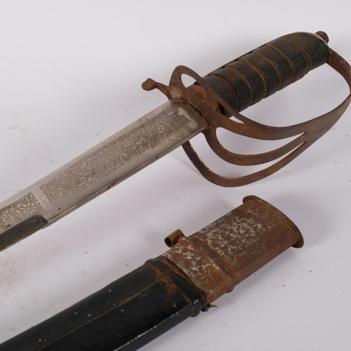 87 - An Indian Cavalry sword and scabbard, having an etched blade and pierced hilt, blade length 77cm, ov... 