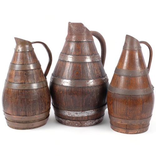 700 - A Continental Vintage coopered oak jug with metal bands, 33cm, and 2 smaller jugs