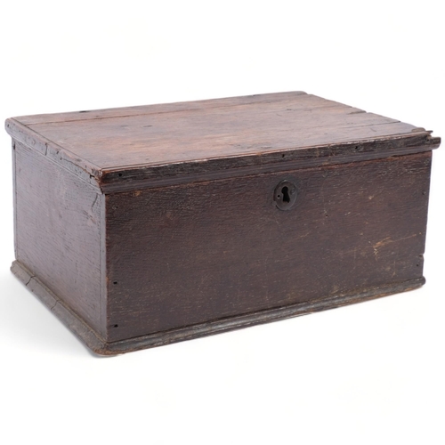 715 - An 18th century oak candle box, with a quantity of candles, 34cm across