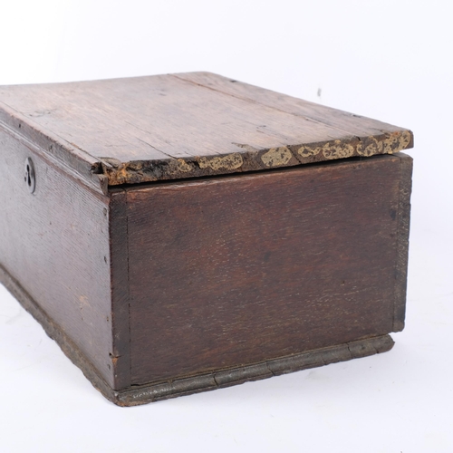 715 - An 18th century oak candle box, with a quantity of candles, 34cm across