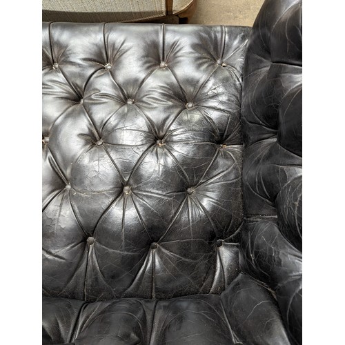 2712 - An vintage black leather Chesterfield style sofa. Overall 230x75x95cm, seat 163x42x60cm.