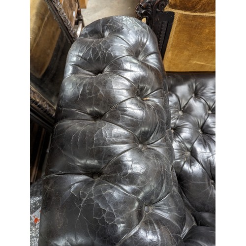 2712 - An vintage black leather Chesterfield style sofa. Overall 230x75x95cm, seat 163x42x60cm.