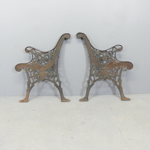 65 - A pair of painted cast-iron bench ends. Height 72cm.