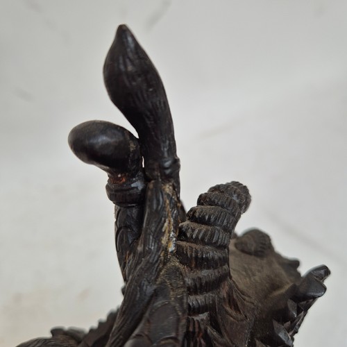 272 - A high quality carved Chinese dragon figure mounted on a serpent, H30cm, and a Chinese carved wood f... 