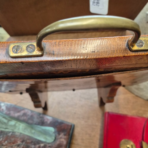 44 - An Art Deco oak and marquetry decorated magazine rack with brass handles, monogramed WHS, H45cm