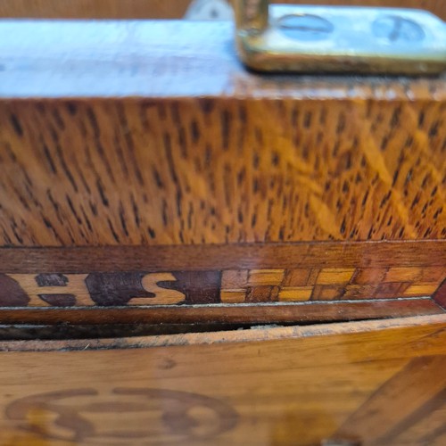 44 - An Art Deco oak and marquetry decorated magazine rack with brass handles, monogramed WHS, H45cm