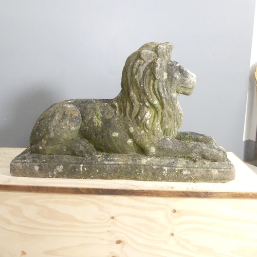 38 - A weathered concrete garden statue, study of a recumbent Lion. 90x56x32cm.