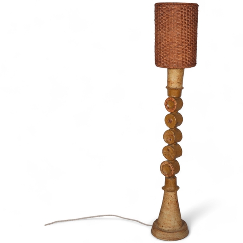 107 - BERNARD ROOKE (b1938), A large brutalist ceramic floor lamp, a round joined totem body, with rattan ... 