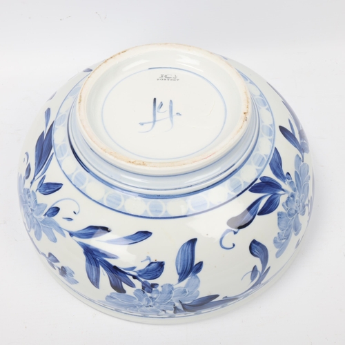 200 - JONATHAN CHISWELL JONES, a studio pottery porcelain bowl with blue and white floral painted glaze, m... 