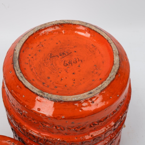 273 - An Italian Bitossi style storage jar and cover, with orange glaze, makers mark to base, height 23cm