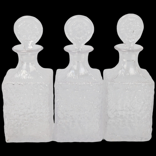 307 - Three Whitefriars Glacier pattern clear glass (flint colourway) whisky decanters, with matching stop... 