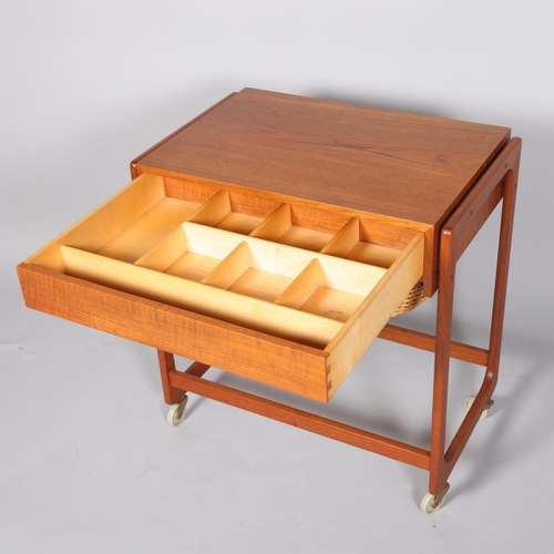 80 - A Mid 20th Century teak sewing trolley/sewing table, with fitted drawer and rattan basket under top,... 