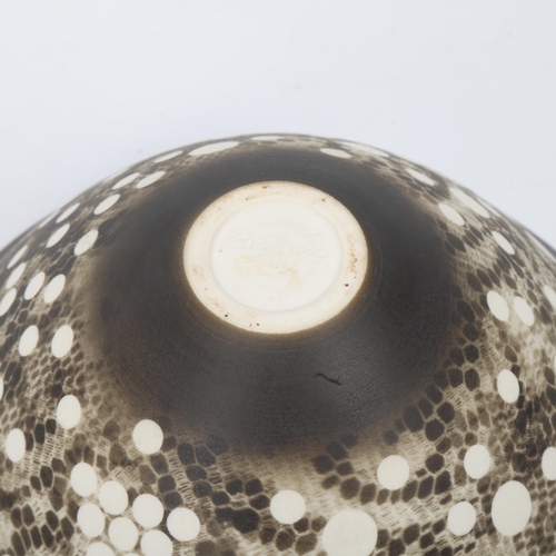 95 - PETER LANE (b.1932) - a studio pottery porcelain bowl, with matt black resist patterned glaze, signe... 