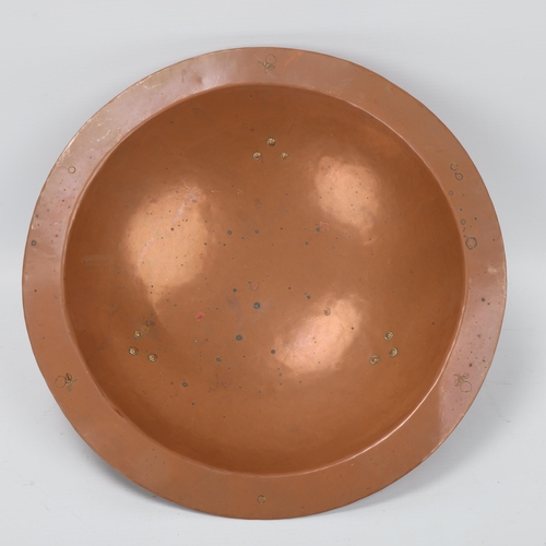 98 - An early 20th century planished copper fruit bowl by the Birmingham Guild Ltd with riveted brass fee... 