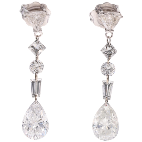 1107 - A pair of 14ct white gold vari-cut diamond drop earrings, London 2010, each earring with trillion-cu... 