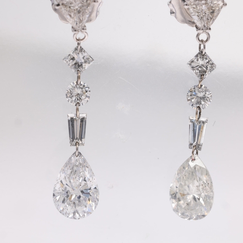 1107 - A pair of 14ct white gold vari-cut diamond drop earrings, London 2010, each earring with trillion-cu... 