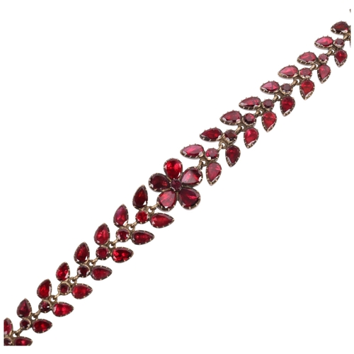 1122 - A Georgian flat-top garnet floral wreath bracelet, circa 1780, the central flowerhead motif flanked ... 