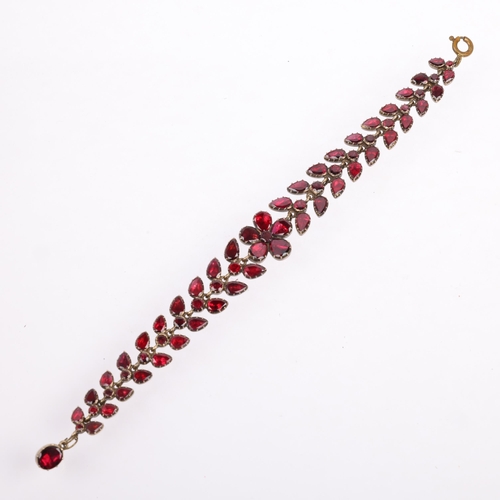 1122 - A Georgian flat-top garnet floral wreath bracelet, circa 1780, the central flowerhead motif flanked ... 