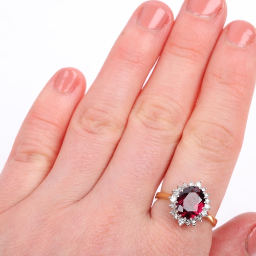 1123 - A late 20th century 18ct gold almandine garnet and diamond oval cluster ring, maker R Ltd, London 19... 