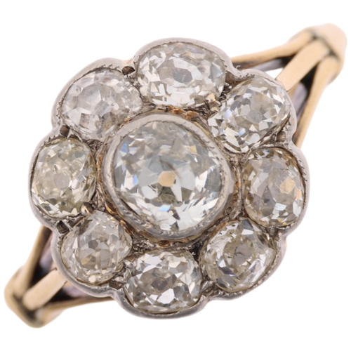 1128 - An 18ct gold diamond flowerhead cluster ring, rub-over set with old-cut diamonds, total diamond cont... 