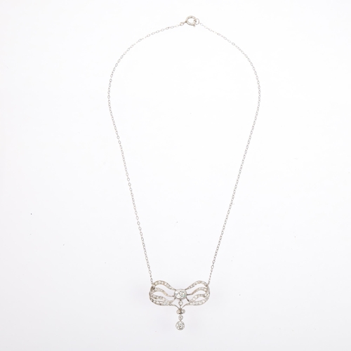 1129 - An Art Nouveau French diamond ribbon bow pendant necklace, circa 1910, set with old and eight-cut di... 