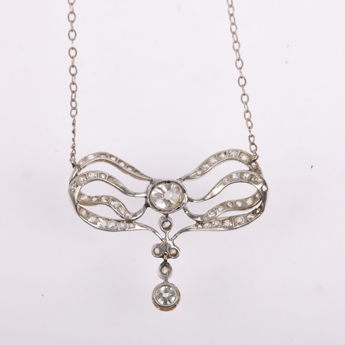 1129 - An Art Nouveau French diamond ribbon bow pendant necklace, circa 1910, set with old and eight-cut di... 