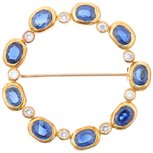 1138 - A late 20th century sapphire and diamond wreath brooch, rub-over set with modern round brilliant-cut... 